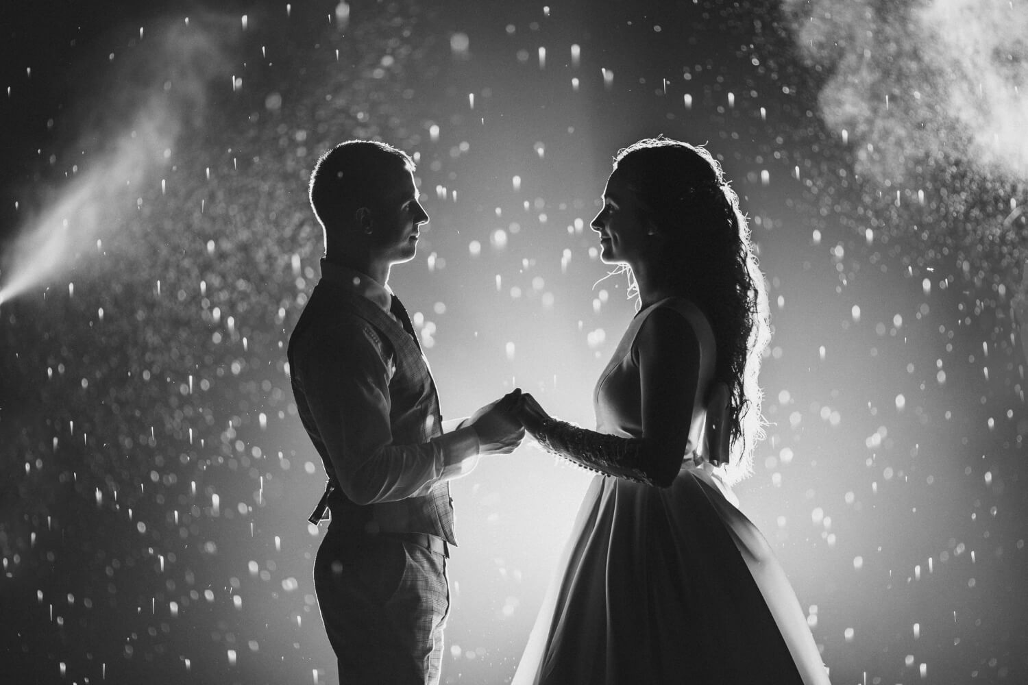 side-view-black-white-stock-photo-cheerful-bride-groom-holding-hands-jpg